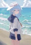  1girl beach blue_eyes blue_hair blue_sailor_collar blue_skirt cloud day flat_cap hair_between_eyes hammer_and_sickle hat hibiki_(kancolle) highres kantai_collection long_hair looking_at_viewer mei_namene neckerchief ocean outdoors pleated_skirt red_neckerchief sailor_collar school_uniform serafuku skirt sky solo verniy_(kancolle) water white_headwear 