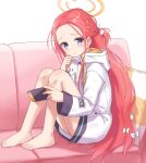  bare_legs barefoot blue_archive blue_eyes blush couch feet hair_ribbon halo handheld_game_console highres holding holding_handheld_game_console knees_up long_hair long_sleeves looking_at_viewer machikado no_shoes on_couch pillow red_hair ribbon sitting very_long_hair yuzu_(blue_archive) 