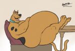 2023 anthro belly big_belly brown_body brown_fur canid canine canis collar collar_only domestic_dog fangs feet_on_table fur furniture great_dane half-closed_eyes hand_on_stomach hanna-barbera kaiipwilde_(artist) leaning leaning_back legs_up looking_at_viewer male mammal mastiff molosser morbidly_obese morbidly_obese_anthro morbidly_obese_male mostly_nude narrowed_eyes nude obese obese_anthro obese_male open_mouth overweight overweight_anthro overweight_male scooby-doo scooby-doo_(series) side_view signature sitting sofa solo table teeth tongue 