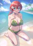  1girl :o aqua_eyes barefoot beach bikini breasts cleavage collarbone commentary day drill_hair emma_verde flower freckles frilled_bikini frills green_bikini hair_flower hair_ornament hand_on_own_chest highres jewelry kneeling large_breasts lens_flare long_hair looking_at_viewer love_live! love_live!_nijigasaki_high_school_idol_club navel open_mouth outdoors pendant red_hair signature sitting solo sugi_(sugi03aurus) swimsuit toes twin_drills white_flower 