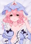  1girl blue_headwear breasts commentary_request hat highres ibuibuyou looking_at_viewer lying medium_hair mob_cap on_back on_bed open_clothes pink_eyes pink_hair saigyouji_yuyuko solo touhou triangular_headpiece upper_body 
