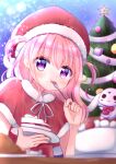  1girl blurry blurry_foreground blush cake cake_slice capelet christmas christmas_tree eating food food_on_face fork fur-trimmed_capelet fur_collar fur_trim hanasakichu hat highres holding holding_fork holding_plate long_hair looking_at_viewer neck_ribbon original pink_hair plate purple_eyes rabbit ribbon santa_costume santa_hat solo two_side_up upper_body 