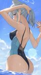  1girl absurdres animal_ears ass backless_swimsuit blue_archive blush breasts competition_swimsuit grey_hair halo higashiwun_izumi highres looking_at_viewer medium_breasts official_alternate_costume one-piece_swimsuit ponytail rubber_band shiroko_(blue_archive) shiroko_(swimsuit)_(blue_archive) sideways_glance smile solo swimsuit two-tone_one-piece_swimsuit tying_hair wading wolf_ears 