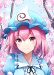  1girl bangs blue_headwear bright_pupils cherry_blossoms closed_mouth commentary hat highres kuneamorai looking_at_viewer medium_hair mob_cap pink_eyes pink_hair saigyouji_yuyuko smile solo touhou triangular_headpiece upper_body white_pupils 