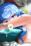  1girl absurdres ahoge armpits blue_hair blue_nails breasts covered_mouth dappled_sunlight flower ganyu_(genshin_impact) genshin_impact hair_between_eyes hair_over_breasts head_on_pillow highres holding holding_flower horns large_breasts long_hair looking_at_viewer lying nail_polish nude on_stomach pillow prev/next purple_eyes qingxin_flower solo sunlight sweat upper_body white_flower window 