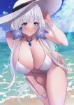  1girl azur_lane bare_shoulders bikini blue_eyes blue_nails blush bracelet breasts cleavage closed_mouth commentary hair_ornament hand_up hat highres illustrious_(azur_lane) jewelry large_breasts large_hat long_hair looking_at_viewer mole mole_under_eye nail_polish necklace ocean outdoors smile solo swimsuit thigh_strap thighs water wee_(weeyy) white_bikini white_hair white_headwear 
