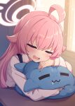  1girl ahoge blue_archive blush closed_eyes crossed_bangs drooling fang feigning_sleep halo highres hoshino_(blue_archive) indoors long_sleeves mouth_drool open_mouth pink_hair pink_halo shinopoko shirt shoulder_strap solo stuffed_animal stuffed_toy stuffed_whale upper_body white_shirt 