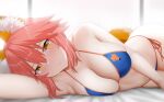  1girl animal_ear_fluff animal_ears arind_yudha arm_up bare_arms bare_shoulders bikini blue_bikini blush breasts cleavage closed_mouth collarbone commentary fang fate/grand_order fate_(series) fox_ears fox_girl fox_print fox_tail hair_between_eyes halterneck highres large_breasts lips looking_at_viewer lying navel on_side orange_trim pink_hair side-tie_bikini_bottom skin_fang smile solo stomach string_bikini swimsuit tail tamamo_(fate) tamamo_no_mae_(swimsuit_lancer)_(fate) tamamo_no_mae_(swimsuit_lancer)_(third_ascension)_(fate) thighs yellow_eyes 