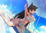  1girl animal_ears arm_up armpits atago_(azur_lane) atago_(summer_march)_(azur_lane) azur_lane barefoot beach bikini black_hair breasts cloud commentary_request day dog_ears dog_girl dutch_angle kagiyama_(clave) large_breasts light_particles looking_at_viewer mole mole_under_eye mouth_hold navel official_alternate_costume outdoors sitting solo swimsuit umbrella white_bikini yellow_eyes 