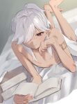  1boy barefoot bed blanket blush book closed_mouth cyno_(genshin_impact) dark-skinned_male dark_skin genshin_impact grey_hair hair_between_eyes highres holding holding_book long_hair lying nude on_bed on_stomach oniichantoitte open_book otoko_no_ko ponytail red_eyes ribs solo white_hair 