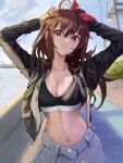  1girl :3 absurdres ahoge arms_up blush breasts brown_hair cleavage cloud cloudy_sky contrapposto cowboy_shot dappled_sunlight day denim english_commentary grass hair_between_eyes highres jacket jeans lamppost large_breasts long_hair looking_at_viewer messy_hair midriff namelessrvon navel open_clothes open_jacket original outdoors pants red_eyes sky solo sports_bra sunlight water zipper 