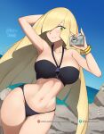  1girl arm_behind_head arm_up barleyshake beach bikini black_bikini blonde_hair breasts camera cleavage closed_mouth day green_eyes hair_over_one_eye highres holding holding_camera large_breasts lusamine_(pokemon) navel outdoors pokemon pokemon_(game) pokemon_sm smile solo swimsuit 