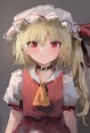  1girl absurdres ascot black_choker blonde_hair choker closed_mouth expressionless flandre_scarlet hair_between_eyes hat heart heart_choker highres light_blush looking_at_viewer mob_cap one_side_up pointy_ears puffy_short_sleeves puffy_sleeves red_eyes red_skirt red_vest reddizen short_sleeves skirt skirt_set slit_pupils solo straight-on touhou vest yellow_ascot 