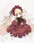  1girl black_bow blonde_hair blue_eyes bonnet bow cake candy capelet circus_tent cookie cup cupcake dress drill_hair flower food highres kiru_(m_putorius) lolita_fashion long_hair looking_at_viewer macaron own_hands_together petals red_capelet red_dress rose rozen_maiden shinku solo stuffed_animal stuffed_rabbit stuffed_toy stuffed_unicorn sugar_cube teacup teapot teddy_bear twintails upper_body very_long_hair 