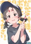  1girl :d baseball_cap black_hair black_shirt blue_headwear blue_skirt blush body_writing brown_eyes clothes_writing collarbone commentary_request english_text forehead forehead_writing gomennasai grey_background hands_up hat highres interlocked_fingers looking_at_viewer low_twintails original own_hands_clasped own_hands_together pleated_skirt shirt short_sleeves simple_background skirt smile solo text_background thick_eyebrows translation_request twintails upper_body 