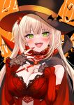  1girl absurdres bare_shoulders black_cape black_headwear blonde_hair blush breasts cape cleavage detached_sleeves dress fangs fingerless_gloves gloves green_eyes hair_ornament halloween highres large_breasts long_hair long_sleeves looking_at_viewer open_mouth orange_background original pointy_ears red_cape red_dress shibakame simple_background smile solo twintails two-tone_cape upper_body vampire 