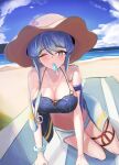  1girl beach bikini blue_bikini blue_eyes blue_hair blue_sky bracelet breasts brown_headwear cleavage cloud dawn_1945 day food gotland_(kancolle) hat highres jewelry kantai_collection long_hair looking_at_viewer mountainous_horizon mouth_hold ocean one_eye_closed outdoors popsicle sky solo sun_hat swimsuit water 