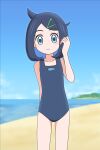  1girl animal_print bare_arms black_one-piece_swimsuit blush closed_mouth collarbone commentary_request cowboy_shot cowlick day eyelashes fish_print hair_ornament hairclip hand_up highres kato-shun liko_(pokemon) looking_at_viewer one-piece_swimsuit outdoors pokemon pokemon_(anime) pokemon_horizons sand school_swimsuit shore solo standing sweatdrop swimsuit water 