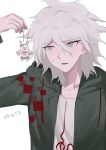  1boy artist_name brown_eyes collarbone danganronpa_(series) danganronpa_2:_goodbye_despair green_jacket grey_hair hair_between_eyes highres holding hood hood_down hooded_jacket jacket komaeda_nagito medium_hair open_clothes open_jacket print_shirt shirt simple_background solo upper_body usami_(danganronpa) waniya_(qhw59) white_background white_shirt 