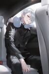  1boy absurdres bishounen black_jacket black_pants candy car_interior earrings food grey_eyes grin hair_over_one_eye highres holding holding_phone jacket jewelry leaning lollipop looking_at_viewer male_focus muaooooo neck_pillow original pants phone seatbelt short_hair sitting slit_pupils smile solo white_hair 