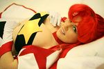  blue_eyes breasts cleavage cosplay gloves large_breasts lying on_back photo ponytail red_hair smile solo space_yoko strapless tengen_toppa_gurren_lagann tubetop yoko_littner 