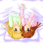  blonde_hair blue_eyes brown_hair fate_testarossa holding_hands long_hair long_sleeves looking_at_another lyrical_nanoha mahou_shoujo_lyrical_nanoha_strikers multiple_girls pajamas pillow red_eyes saki_chisuzu shared_blanket shared_pillow smile takamachi_nanoha under_covers upside-down yuri 