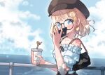  1girl bag bra_strap commentary cup disposable_cup earrings freckles glasses handbag hat heart heart_earrings highres holding holding_cup hololive hololive_english jewelry kfp_employee_(takanashi_kiara) kiirokuma looking_at_viewer ocean off-shoulder_shirt off_shoulder official_alternate_costume railing round_eyewear shirt smile solo upper_body virtual_youtuber watson_amelia watson_amelia_(2nd_costume) 