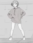  1girl ankle_socks bob_cut brick_wall commentary drawstring english_commentary full_body greyscale hands_on_own_hips highres holding hood hood_down long_hoodie looking_afar monochrome no_pants open_mouth original shoes short_hair side_ponytail smaragdus smile sneakers socks solo spread_legs standing upturned_eyes 