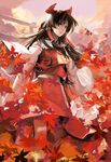  absurdres ascot autumn brown_hair cloud detached_sleeves hair_ornament hair_ribbon hakurei_reimu highres leaf lips long_hair nanacoco red red_eyes ribbon skirt sky solo torii touhou wide_sleeves wind 