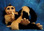  banana cute food fruit fursuit looking_at_viewer lying male mammal media monkey nightmare_fuel orange_eyes paws pose primate real solo 