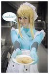  1girl apron blonde_hair blue_eyes caucasian cookie cookies cosplay food haylay_williams looking_at_viewer metroid mewtwo2222 nintendo non-asian photo samus_aran smile solo zero_suit 