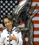  alien america biting_political_commentary female flag michelle_obama what xenomorph 