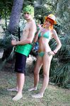  1boy 1girl barefoot bikini cosplay female green_hair hat highres kamichanoo lockpost male nami nami_(cosplay) nami_(one_piece) nami_(one_piece)_(cosplay) one_piece photo real red_hair roronoa_zoro standing straw_hat strawhat swimsuit sword weapon 
