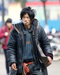  1boy asian beggar black_hair brother_sharp chinese cigarette homeless mustache outdoors photo real smoking 