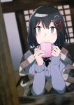  1girl black_hair blanket blush brown_eyes buttons closed_mouth cup from_outside grey_sweater haguro_(kancolle) hair_between_eyes hair_ornament holding holding_cup indoors kantai_collection long_sleeves mido006 mug solo sweater upper_body window 