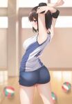  1girl armpits arms_up ass ball blue_shorts blurry blurry_background breasts brown_eyes brown_hair elbow_pads elbow_sleeve gym_shorts highres indoors knee_pads large_breasts minato_ojitan original shirt shorts sleeveless sleeveless_shirt sportswear volleyball volleyball_uniform 