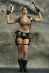  arms_up boots breasts brown_hair cosplay dual_wield female fingerless_gloves girl gloves gun hotpants karima_adebibe lara_croft large_breasts legs long_hair midriff navel photo pistol ponytail shirt shorts socks solo standing tomb_raider weapon 