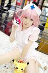  asian cosplay hat joy_(pokemon) nurse photo pikachu pink_hair poke_ball pokeball pokemon purple_eyes sitting 