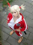  bleach blonde_hair cosplay highres photo sarugaki_hiyori sarugaki_hiyori_(cosplay) sword track_suit vizard weapon 