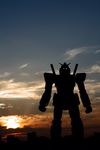  cloud glowing glowing_eyes gundam japan mecha mobile_suit_gundam model no_humans outdoors photo rx-78-2 silhouette sky sunset 