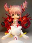  blurry chibi creature depth_of_field figure from_behind gundam gundam_age gundam_age-1 gundam_age-1_titus highres kaname_madoka kyubey magical_girl mahou_shoujo_madoka_magica mecha_musume mechanical_arms mechanical_legs nendoroid non-web_source o_o photo pink_hair short_hair short_twintails twintails 