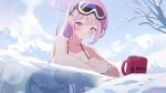  1girl bikini black_bikini blue_archive blush breasts chikoku cup eimi_(swimsuit)_(blue_archive) goggles goggles_on_head halo highres large_breasts leaning_forward long_hair looking_at_viewer mug official_alternate_costume outdoors partially_submerged pink_eyes pink_hair side-tie_bikini_bottom ski_goggles smile snow solo string_bikini swimsuit very_long_hair 