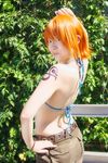  1girl amanone_shun asian belt bikini_top bracelet camouflage cargo_shorts cosplay female jewelry midriff nami nami_(cosplay) nami_(one_piece) nami_(one_piece)_(cosplay) one_piece orange_hair outdoors photo plant skypiea solo tattoo 