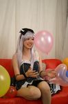  1girl balloon balloons bow cosplay couch dress hair_bow hairbow photo polka_dot red_upholstery ribbon saya saya_(cosplayer) silver_hair smile 