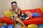  1girl balloon balloons bow cosplay couch dress hair_bow hairbow photo polka_dot polka_dot_dress red_upholstery ribbon saya saya_(cosplayer) silver_hair smile 