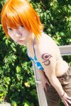 1girl amanone_shun asian belt bikini_top bracelet camouflage cargo_shorts cosplay female jewelry midriff nami nami_(cosplay) nami_(one_piece) nami_(one_piece)_(cosplay) one_piece orange_hair outdoors photo plant skypiea solo tattoo 