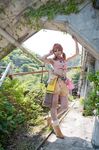  1girl belt bracelet cosplay female final_fantasy final_fantasy_xiii jewelry leaning midriff necklace oerba_dia_vanille oerba_dia_vanille_(cosplay) outdoors photo pipe plant roadway skirt solo tree twintails 