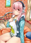  1girl :3 bed blush breasts headphones icebox jacket large_breasts long_hair nitroplus pillow pink_eyes pink_hair shorts sitting smile solo sonico super_sonico 