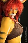  bodypaint clothed clothing cosplay ear_piercing feathers feline female hair leather mammal piercing red_hair skimpy tiger tribal_clothing yuricocosplay yurikocosplay 