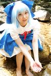  1girl asian barefoot blue_dress blue_hair bow cirno cirno_(cosplay) cosplay dress feet highres lenfried looking_at_viewer looking_up mole photo rock touhou water wig wings 